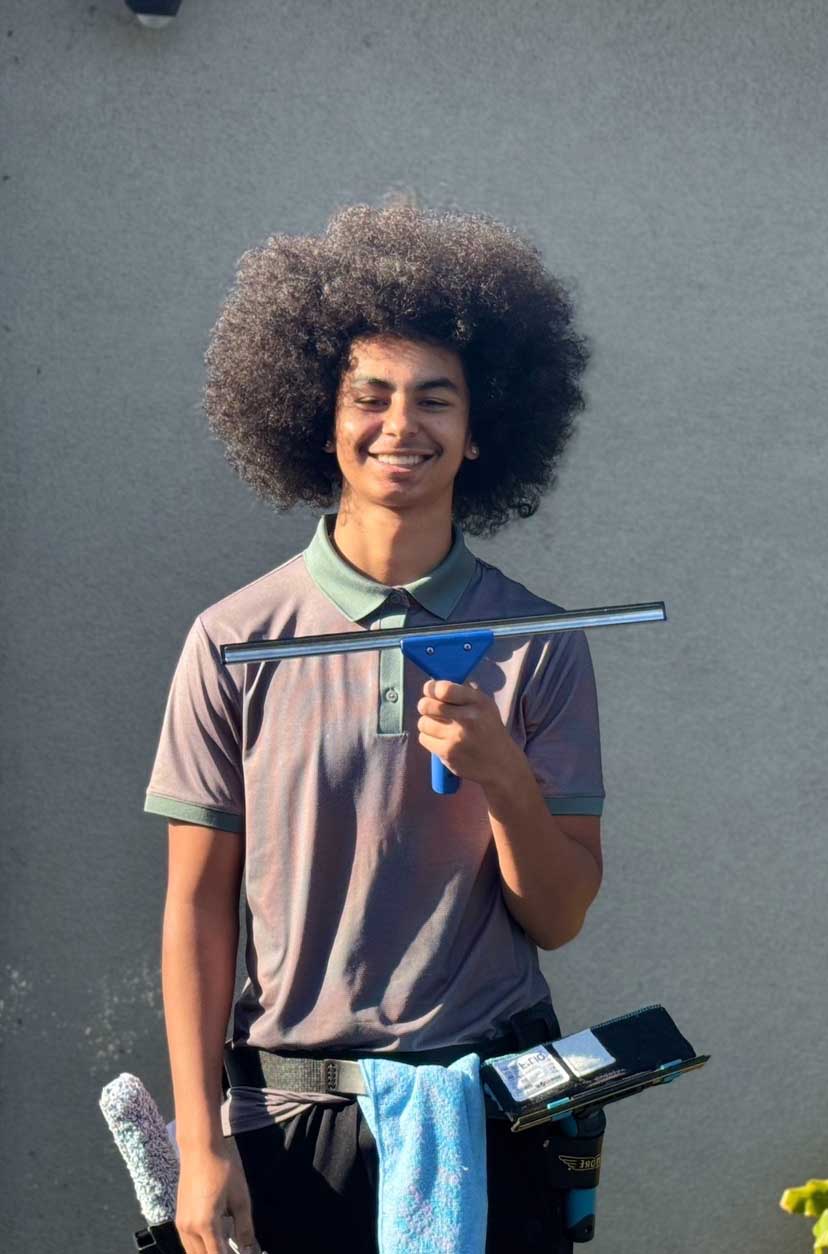 Gianni, founder of Shine & Clean in Santa Rosa with window cleaning gear squeegee, and tool belt.